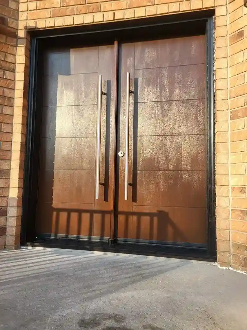 Custom modern double entry door with pull bars, installed by EHI Custom Doors